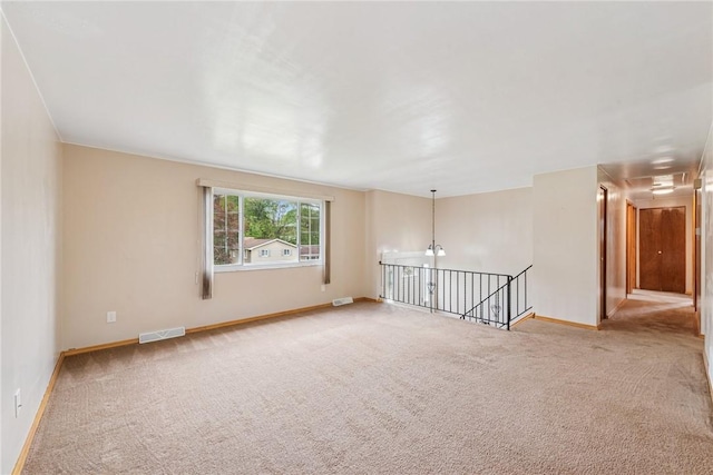 empty room featuring carpet flooring and baseboards