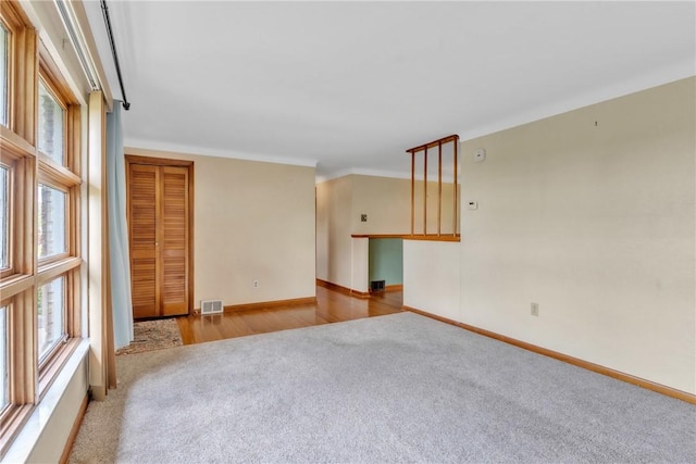 empty room with carpet flooring and baseboards