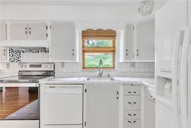 kitchen featuring white appliances, a sink, white cabinets, tasteful backsplash, and light countertops