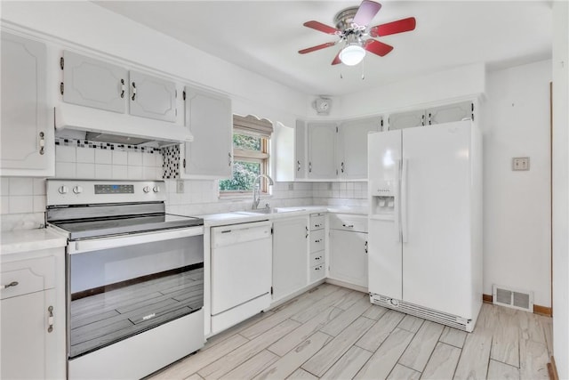 kitchen featuring white appliances, under cabinet range hood, a sink, a ceiling fan, and tasteful backsplash