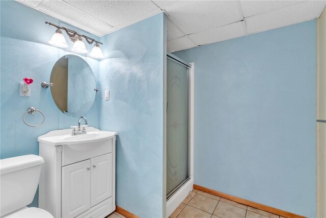 full bathroom featuring a shower stall, toilet, tile patterned flooring, vanity, and baseboards