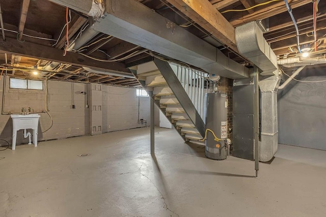 basement featuring gas water heater, stairway, and heating unit