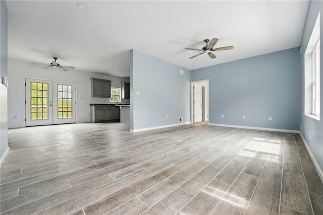 958 Cliff Mine Rd, Coraopolis, PA 15108 - unfurnished living room featuring a ceiling fan, light wood-style flooring, and baseboards
