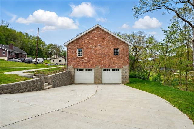 958 Cliff Mine Rd, Coraopolis, PA 15108 - view of side of property with driveway, a garage, brick siding, and a lawn