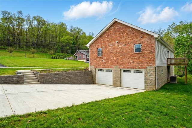 958 Cliff Mine Rd, Coraopolis, PA 15108 - view of side of home with central AC unit, a garage, concrete driveway, a yard, and brick siding