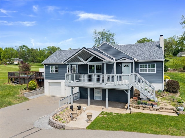 10 Chestnut Ln, Finleyville, PA 15332 - view of front of house featuring a wooden deck, a chimney, an attached garage, stairs, and asphalt driveway