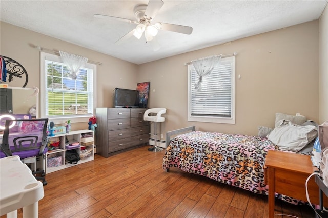 10 Chestnut Ln, Finleyville, PA 15332 - bedroom with wood-type flooring, a baseboard heating unit, and a ceiling fan