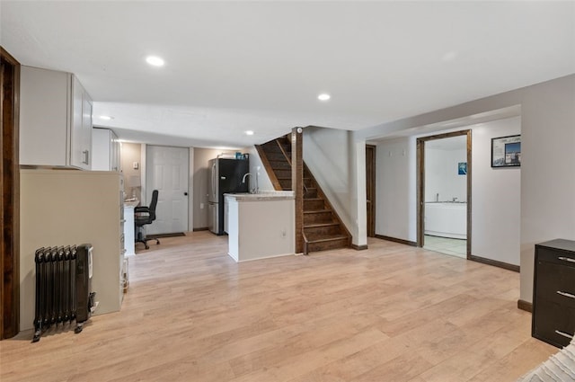 10 Chestnut Ln, Finleyville, PA 15332 - unfurnished living room with radiator heating unit, light wood finished floors, baseboards, stairs, and recessed lighting