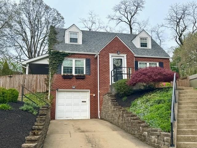 cape cod house with brick siding, stairs, concrete driveway, and fence