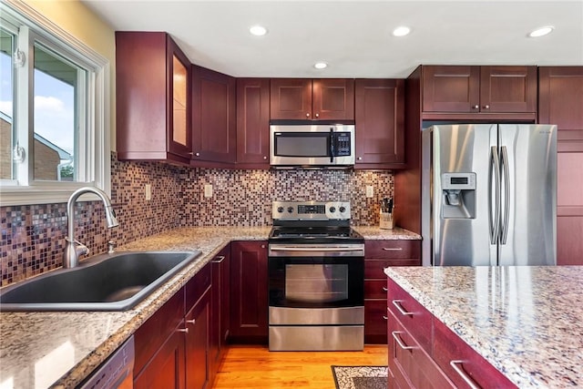 117 Teal Dr, Kennedy Twp, PA 15136 - kitchen with appliances with stainless steel finishes, a sink, light wood-style floors, dark brown cabinets, and glass insert cabinets
