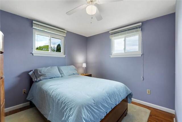 117 Teal Dr, Kennedy Twp, PA 15136 - bedroom with multiple windows, baseboards, wood finished floors, and a ceiling fan