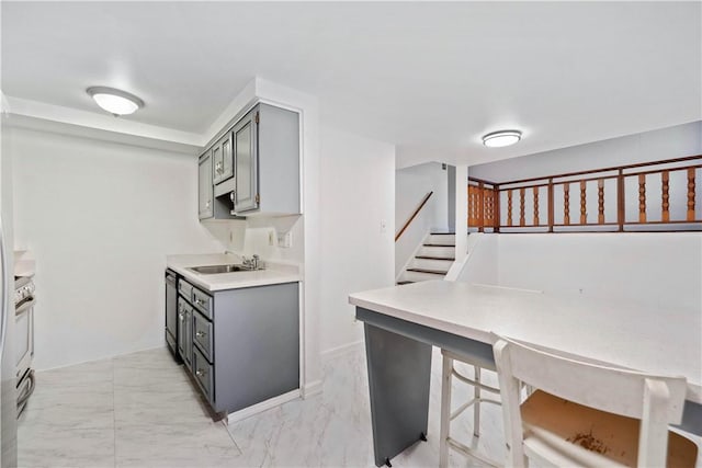 412 Palomino Dr, North Fayette, PA 15071 - kitchen with a sink, gray cabinets, light countertops, and light marble finish flooring