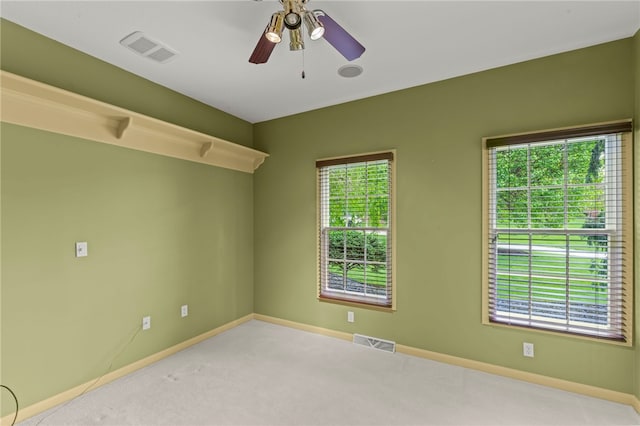 unfurnished room with baseboards, carpet flooring, and a ceiling fan