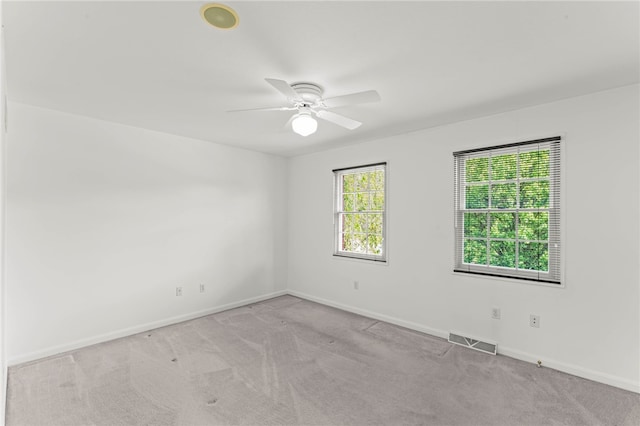 empty room featuring carpet floors, baseboards, and a ceiling fan