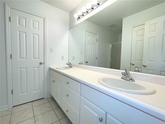 full bath featuring tile patterned floors, a shower stall, and double vanity