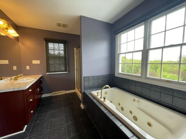 bathroom with vanity, tile patterned floors, a whirlpool tub, baseboards, and a stall shower