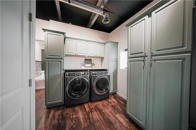 laundry room featuring cabinet space, washing machine and dryer, and dark wood-style flooring