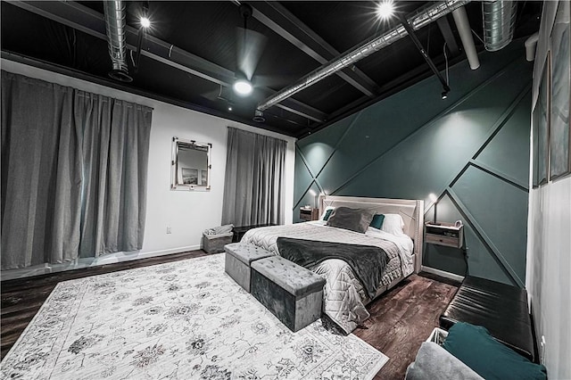bedroom with wood finished floors and baseboards