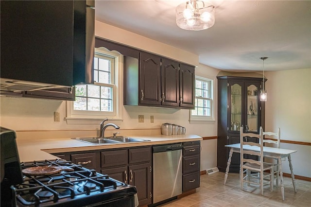 kitchen with dishwasher, a sink, light countertops, and baseboards