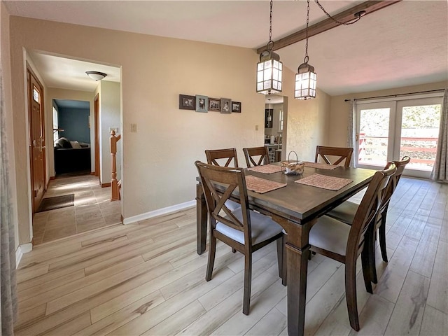 dining space featuring light wood finished floors and baseboards