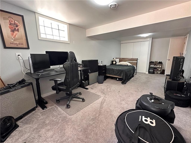 carpeted bedroom featuring an office area