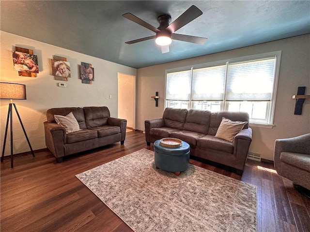 living area featuring ceiling fan, dark wood finished floors, and baseboards