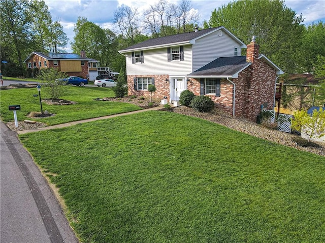 traditional-style home featuring a chimney, a front lawn, brick siding, and a shingled roof