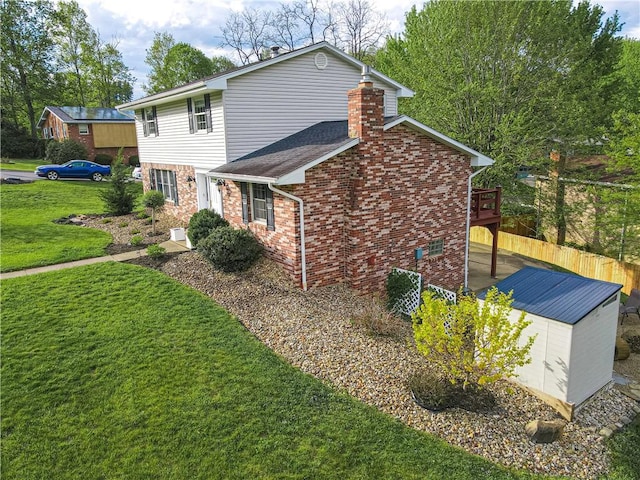 view of home's exterior with a chimney, brick siding, and a deck
