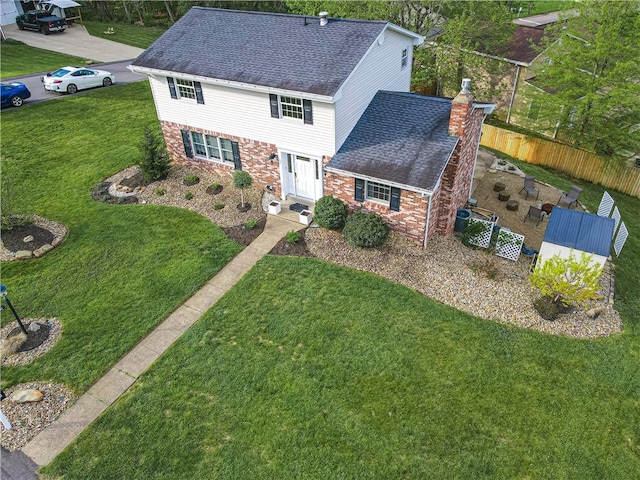 view of front of property with a chimney, brick siding, roof with shingles, and central AC