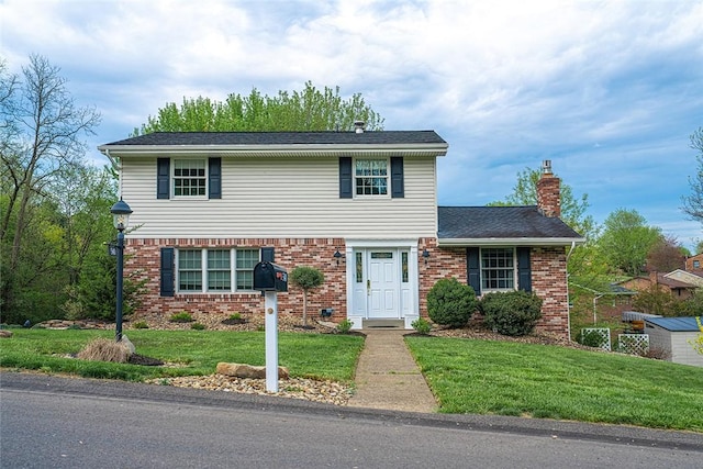 traditional home with brick siding, a front lawn, and a chimney