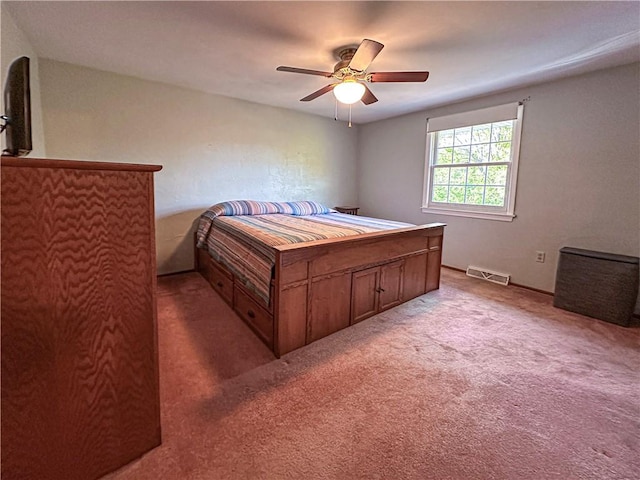 bedroom featuring light carpet and a ceiling fan