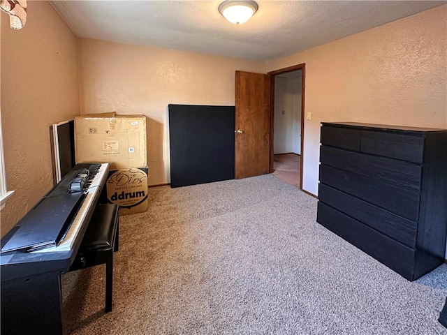 interior space with a textured wall and carpet floors