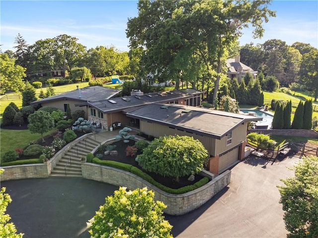 view of subject property featuring a tree filled landscape