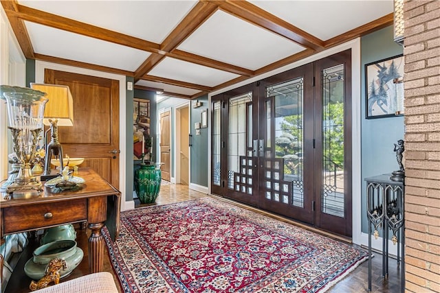 foyer entrance with baseboards, coffered ceiling, and beamed ceiling
