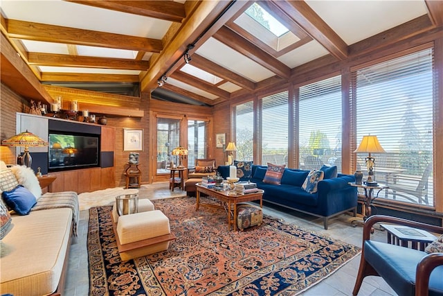 living area with a skylight, wooden walls, and tile patterned flooring