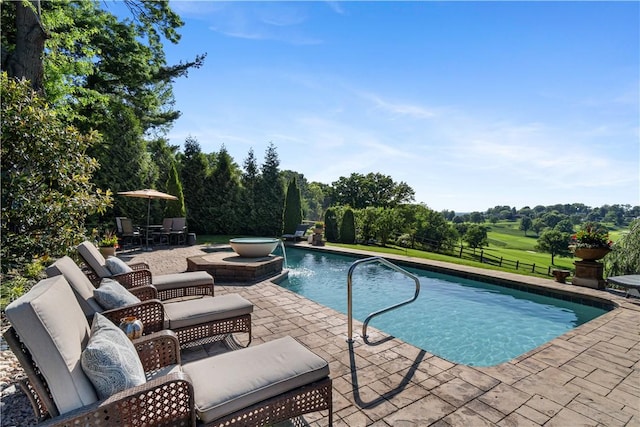 outdoor pool with a patio area and fence