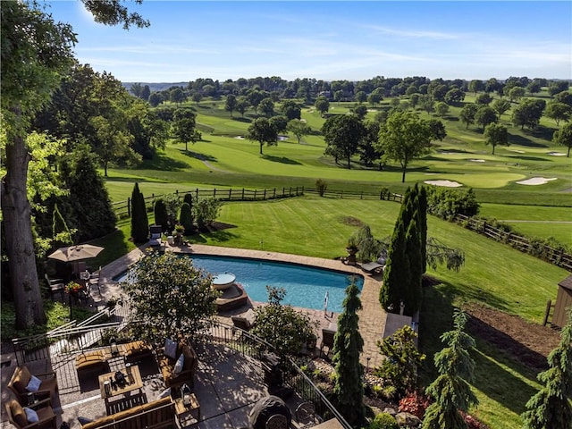 view of swimming pool featuring view of golf course