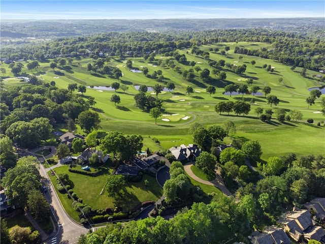 view of property location with a nearby body of water and a local golf course