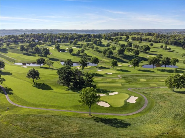 drone / aerial view of a large body of water and a golf course