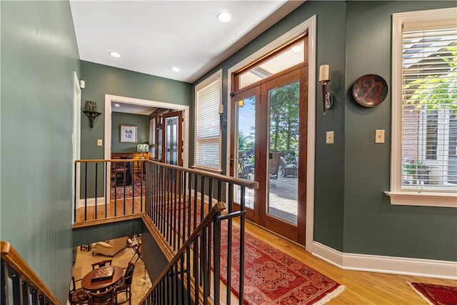 entryway featuring light wood-style floors, baseboards, recessed lighting, and french doors