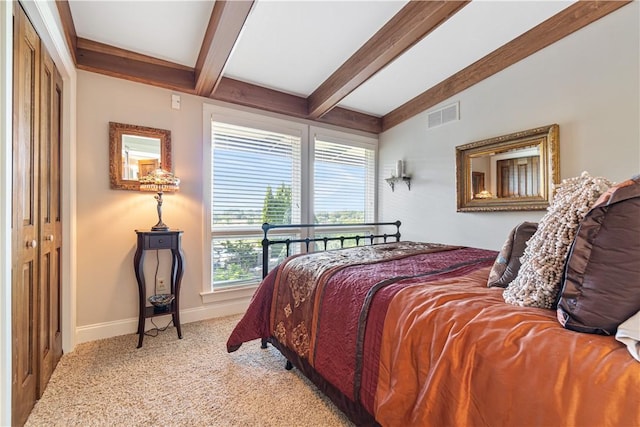 carpeted bedroom featuring beamed ceiling and baseboards