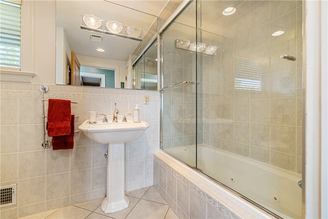 bathroom featuring tile walls, tile patterned flooring, and a combined bath / shower with jetted tub