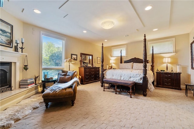 bedroom featuring a fireplace, light carpet, and recessed lighting