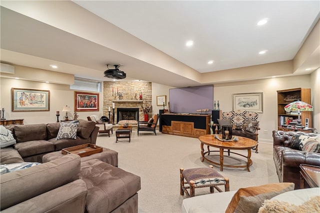 living room featuring light carpet, a fireplace, and recessed lighting