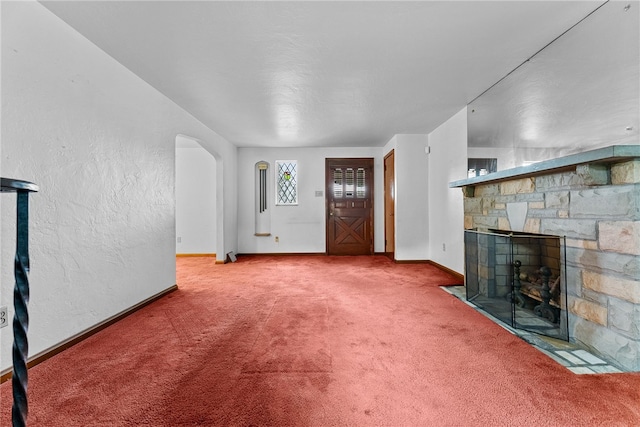 2405 Whited St, Brookline, PA 15226 - unfurnished living room with baseboards, carpet flooring, a fireplace, and arched walkways