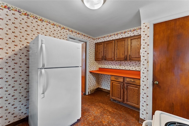 2405 Whited St, Brookline, PA 15226 - kitchen with freestanding refrigerator, wallpapered walls, brown cabinets, and baseboards