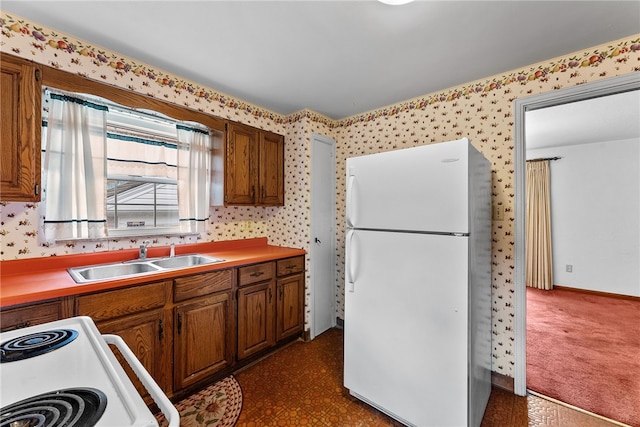 2405 Whited St, Brookline, PA 15226 - kitchen with white appliances, a sink, brown cabinetry, wallpapered walls, and light countertops