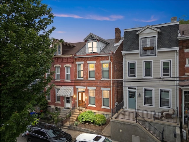 526 Armandale St, Central North Side, PA 15212 - townhome / multi-family property with a chimney, brick siding, and a shingled roof
