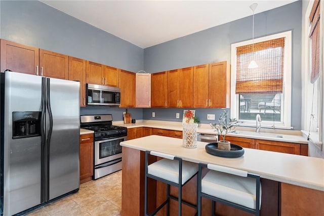 526 Armandale St, Central North Side, PA 15212 - kitchen featuring appliances with stainless steel finishes, brown cabinetry, a sink, and light countertops
