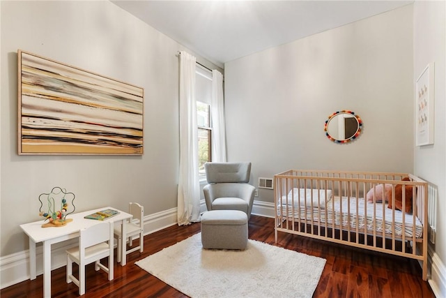 526 Armandale St, Central North Side, PA 15212 - bedroom with baseboards, a nursery area, and wood finished floors